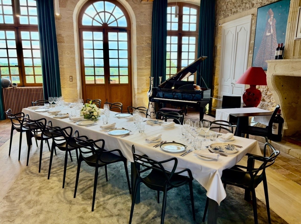 Grand Salon set for dinner with piano and fireplace